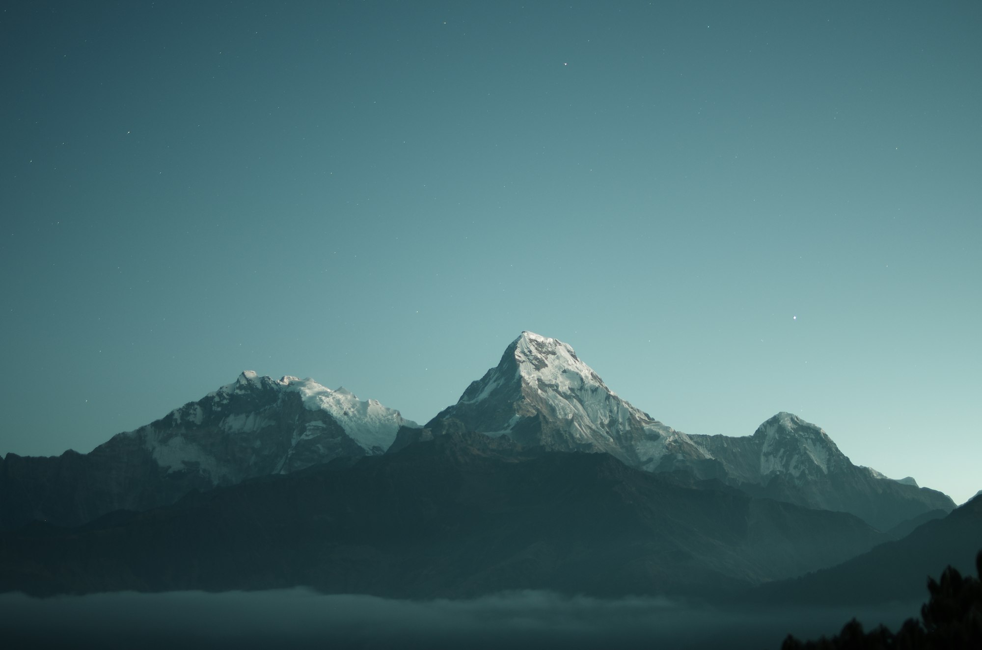 A long range of grey mountain ridges above a valley